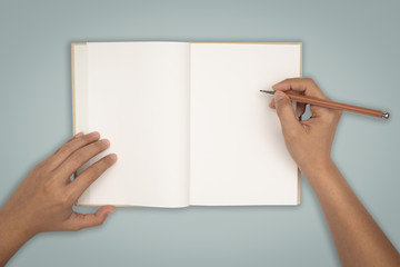 Top view- two hands hold a empty book spread