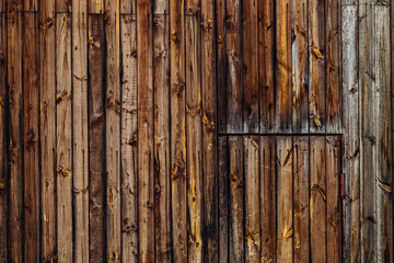 a close-up of a wall of wooden boards and doors.