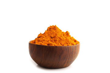 Turmeric powder (Curcuma) in wooden bowls on white background, herbal
