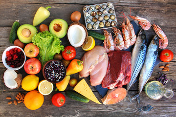 Healthy food on old wooden background. Concept of proper nutrition. Top view. Flat lay.