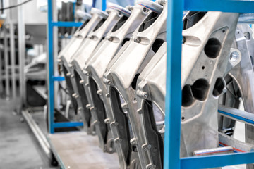 Aluminum automotive parts arm rear hang on a cart, casting process in the automotive factory