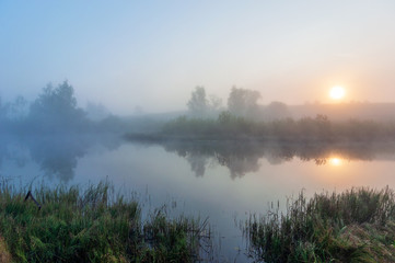 Fototapeta na wymiar morning fog over the lake in the morning