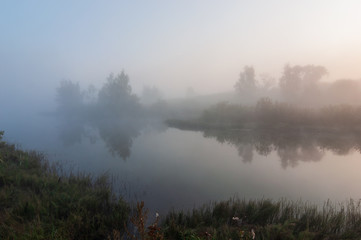Fototapeta na wymiar morning fog over the lake in the morning