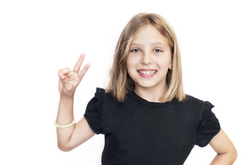 Beautiful young girl on white background with blond hair smiling and showing class with two fingers on a white background