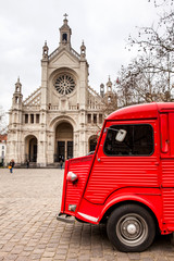 Fototapeta na wymiar St. Catherine's Church and the vintage red food truck in a freezing winter day