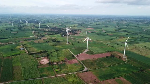 Aerial view of Windmills for electric power production at Huai Bong, Dan Khun Thot district, Nakhon Ratchasima. Large wind turbines were surrounded by corn field, Potato field and sugarcane field