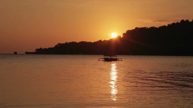 Boat and sunset in the sea timelapse