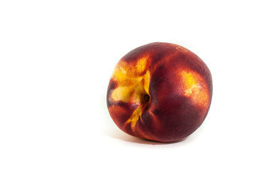 Peach or nectarine isolated on white background in closeup