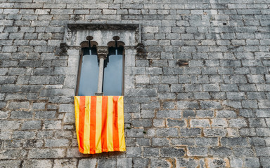 Senyera flag on window frame in Girona, Spain