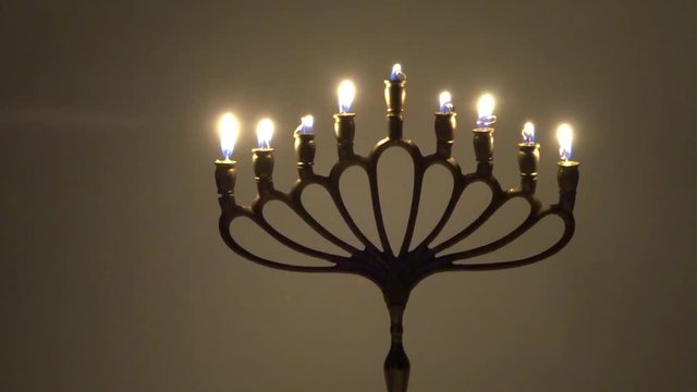 Jewish Hanukkah with tanning candles in motion - judaica simbol for Hanukkah