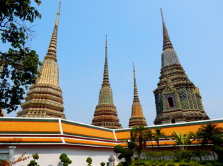 Fototapeta premium The tops of the stupas of the Buddhist temple