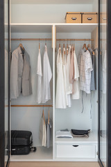 modern closet with clothes