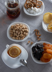 Tea with lemon. dried fruts and pistachios