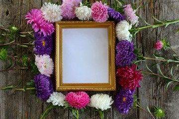 Blue and pink asters on an aged vintage background and a sheet of white paper