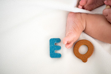 EQ text wooden word on blanket with blurred kid foot and copy space background, Emotional Quotient