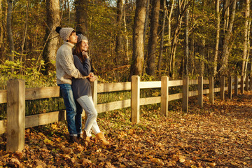 Fototapeta premium Young couple in the park at sunny autumn day