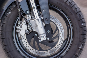 a close-up of the front wheel of a motorcycle with brakes