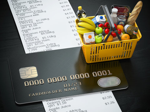 Shopping basket with food and drink, cerdit card and receipt with list of expenses.Purchasing products onlaine by credit card or family budjet concept.