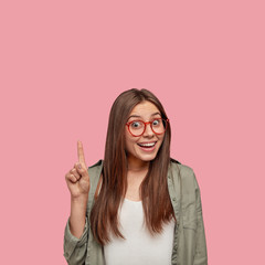 Smiling happy emotional sensitive Caucasian student graduated from universirty, raises fore finger...