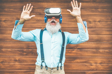 Mature trendy man having fun with virtual reality goggles technology