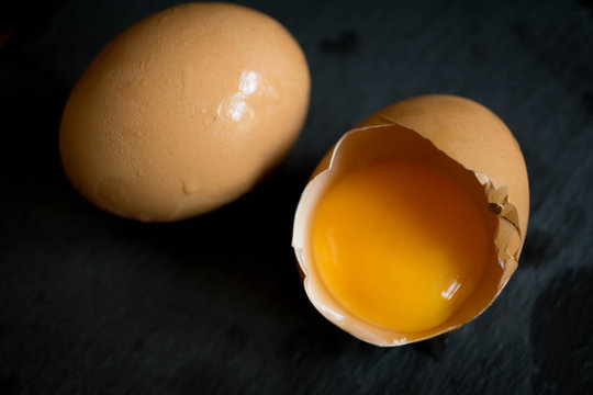 blur cracked open eggs in black background