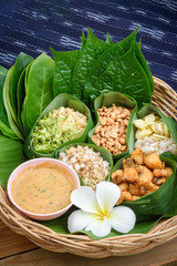 Fototapeta na wymiar set of food wrapped in leaves called miang lay on banana leaf
