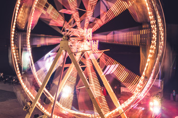 Ferris wheel in a night park. Entertainment in the carnival park.