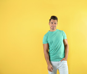 Young man in t-shirt on color background. Mockup for design