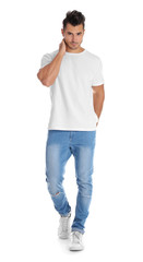 Young man in stylish jeans on white background