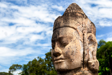 Fototapeta na wymiar Head of gate guardian statue at the entrance of Angkor Thom Camb
