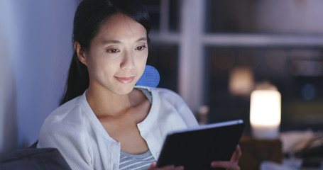 Woman watch on tablet at night