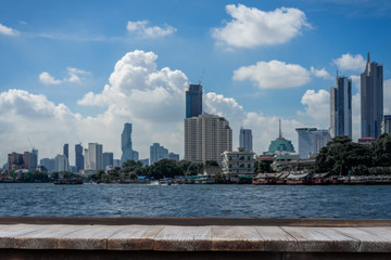 Obraz premium Business concept - Wood table top on blur city scape background, Bangkok, Thailand. Can be used for display or montage your products or design key visual layout.