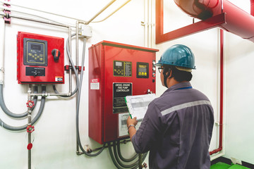 Engineer checking industrial generator fire control system