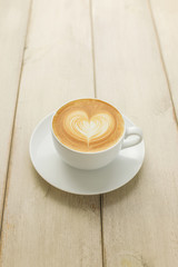 Hot coffee latte isolated on wooden table
