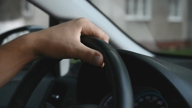 Hand man driving car, slow motion