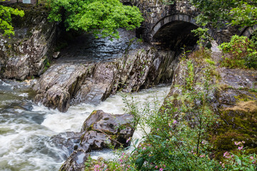 Traditional bridge and rapids of  Betws-y-Coed town in Snowdonia National Park in  Wales, UK