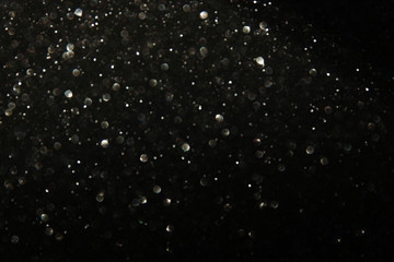 glitter black and silver lights background. de-focused.