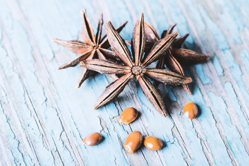Star anise with seeds on old wooden background close-up with copyspace.