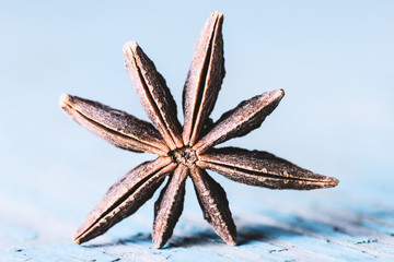 Star anise on old wooden background close-up with copyspace.