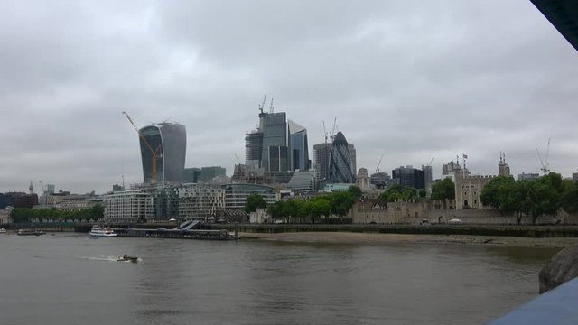 View of London cityscape with Thames river and Tower of London, Shards - tallest glass modern building in the background. View from Tower Bridge.