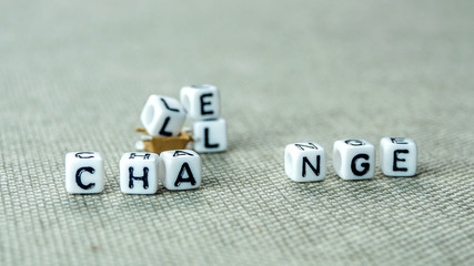 Removing white cubes with letters l and e of the word challenge creating new word change on grey...