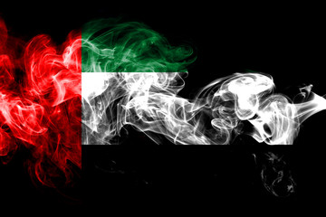 National flag of United Arab Emirates made from colored smoke isolated on black background. Abstract silky wave background.