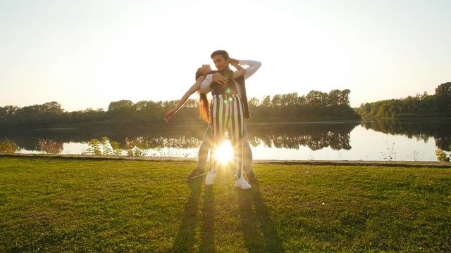 Concept of love and relationships. Young couple dancing at sunset