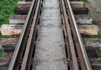 Fototapeta na wymiar Old railway line with the metal board walkway.