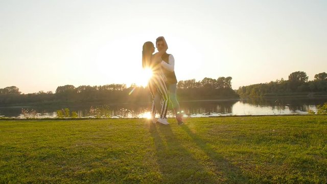 Concept of love and relationships. Young couple dancing at sunset