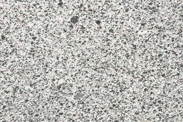 Facing material granite horizontal texture. Natural stone grey granite background.