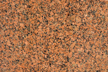 Natural stone red granite background. Bright hard red granite rock texture.