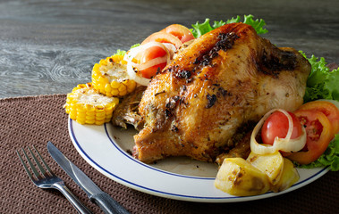 Baked chicken in white dish and Stick rice on brown wooden table