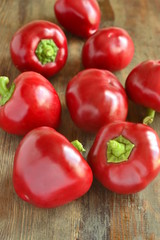 Sweet red pepper on the wooden background,  rotunda