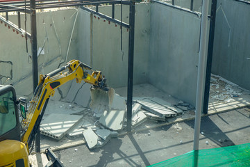 excavator backhoe destroy building